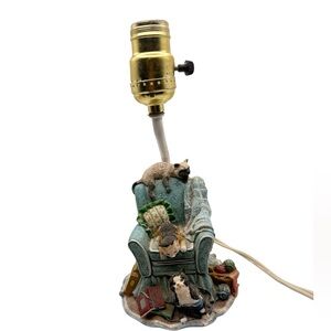 Siamese, Calico, and Tuxedo cat lounging on a green armchair Figurine Lamp.